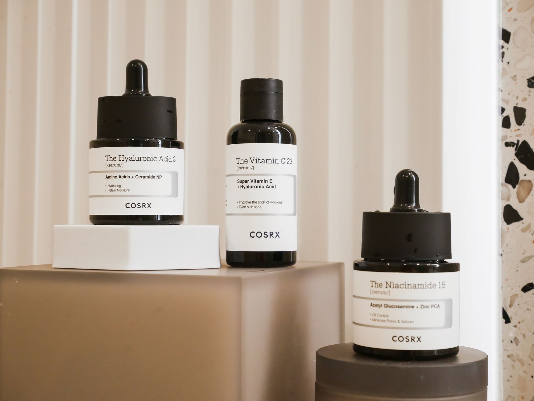 A lineup of Korean skincare serum bottles on display.