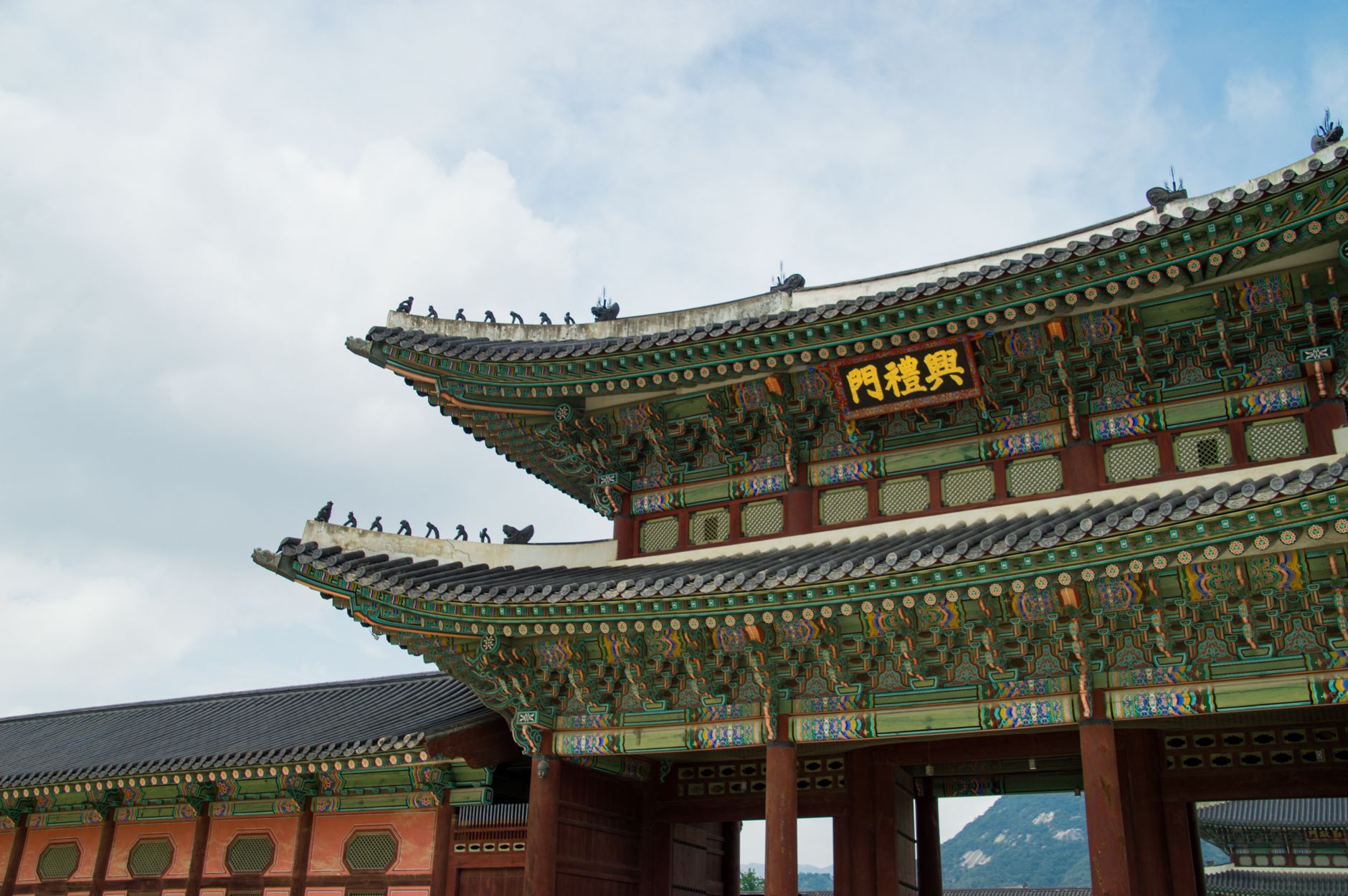 The ornate eaves and rooftop of a main hall at Gyeongbokgung Palace in Seoul.