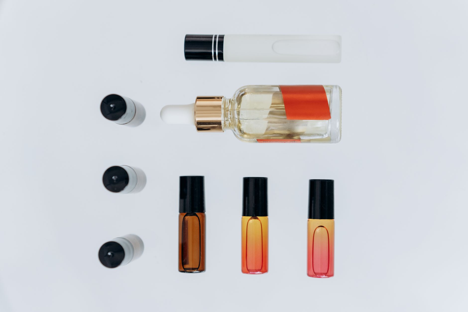Elegant flat lay featuring aromatherapy bottles and pipette, perfect for skincare and wellness themes.