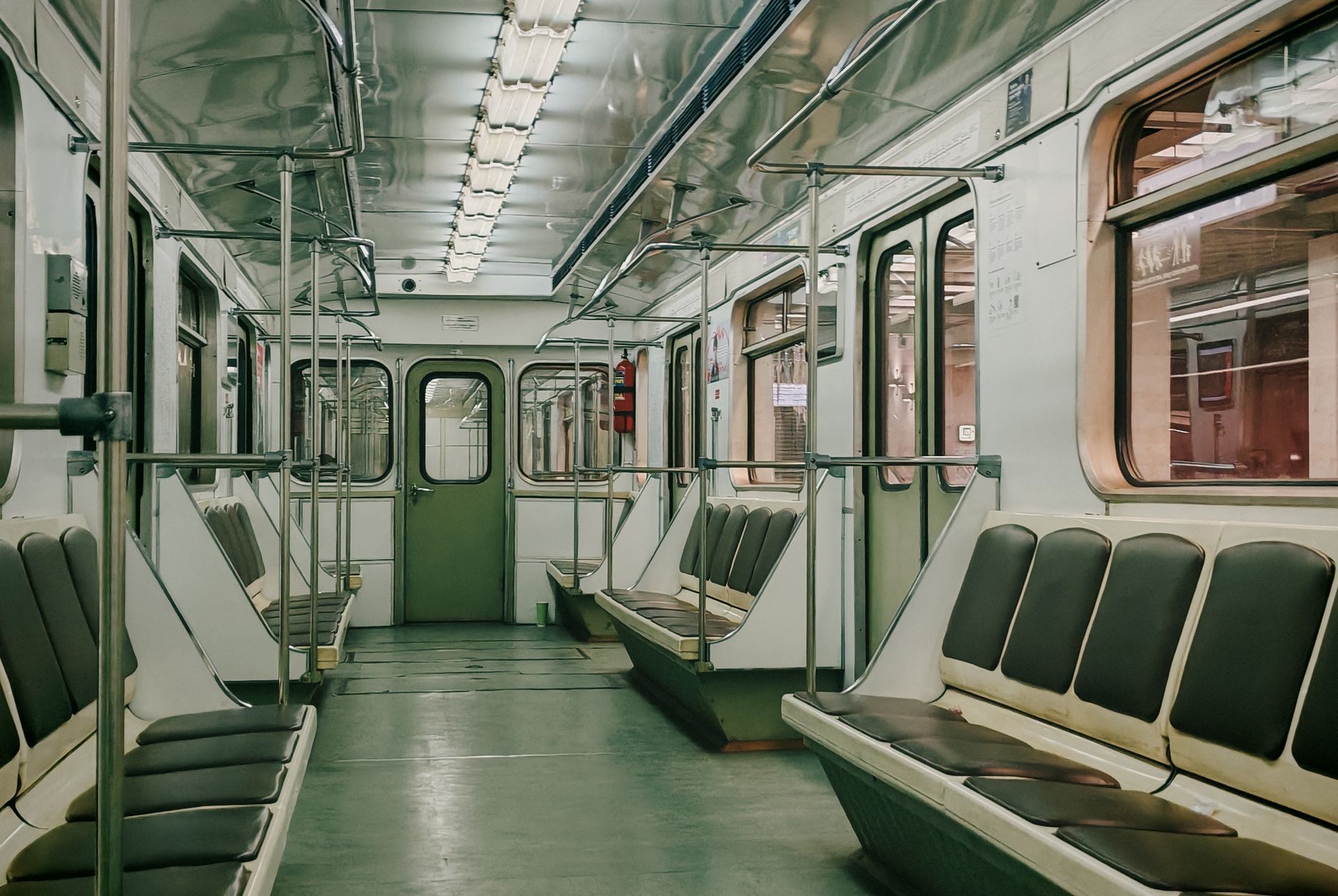 Interior view of an empty Moscow Metro subway car showcasing its classic design and seating arrangement.