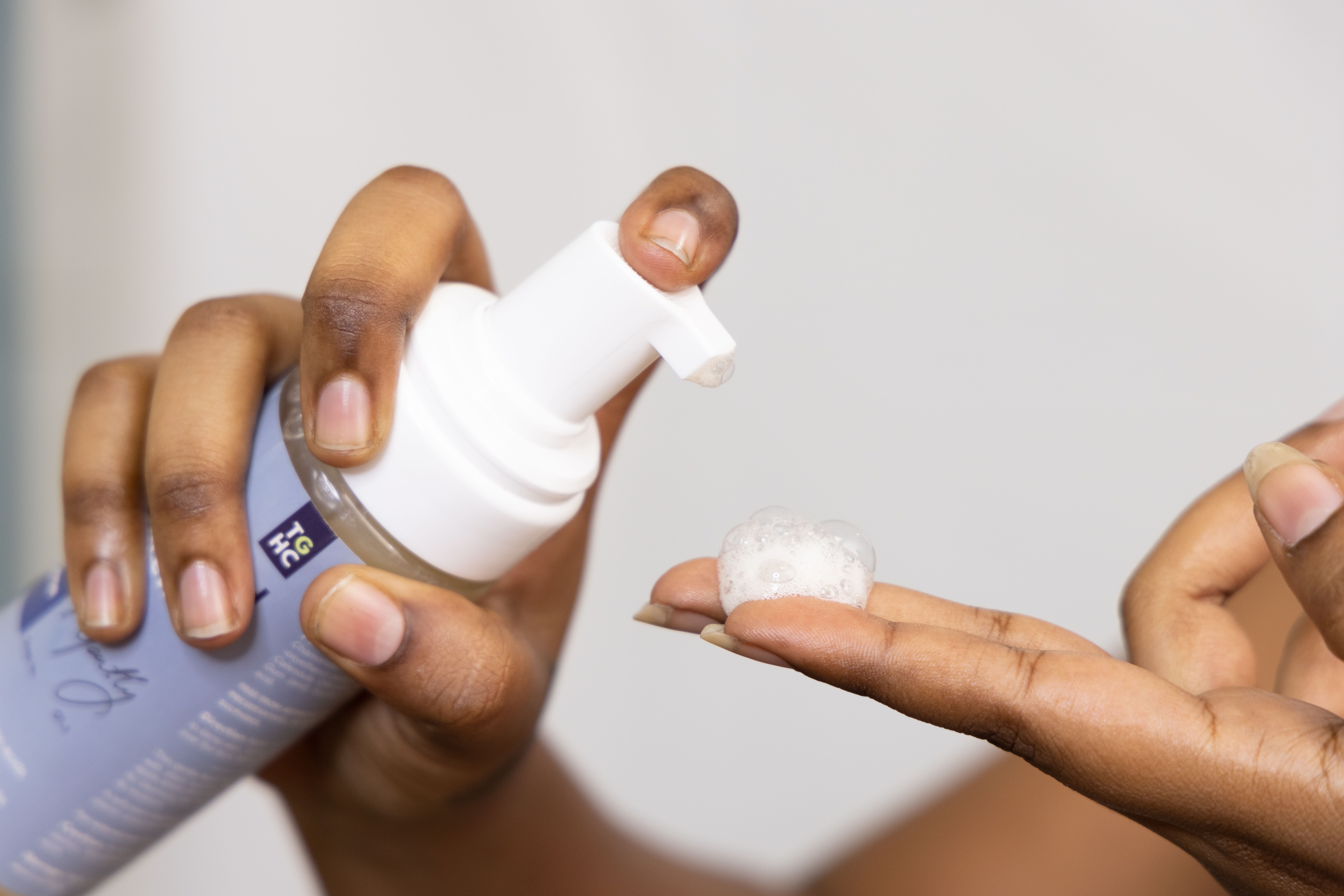 Dispensing a mild Korean cleanser foam onto the hand — K-beauty reference photo