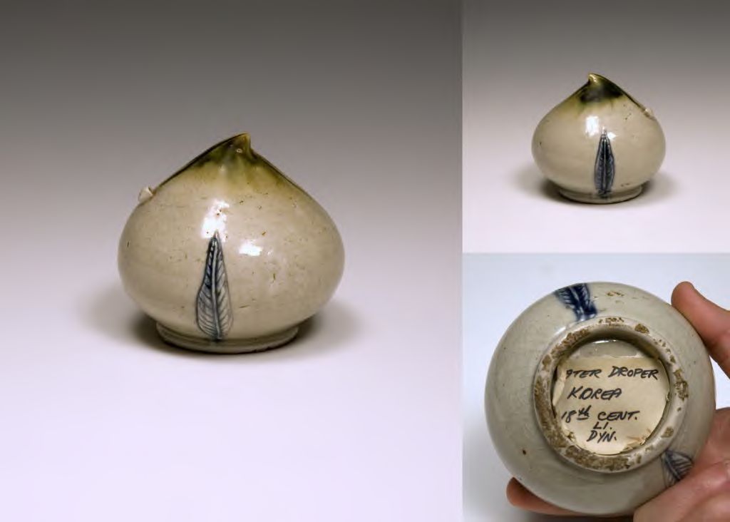 Stoneware water dropper is peach-shaped with a green glaze over white and blue glaze leaf decorations on the side. Tape on the bottom of the object reads 'Water Droper (sic) Korea 18th Cent. Li Dyn.'