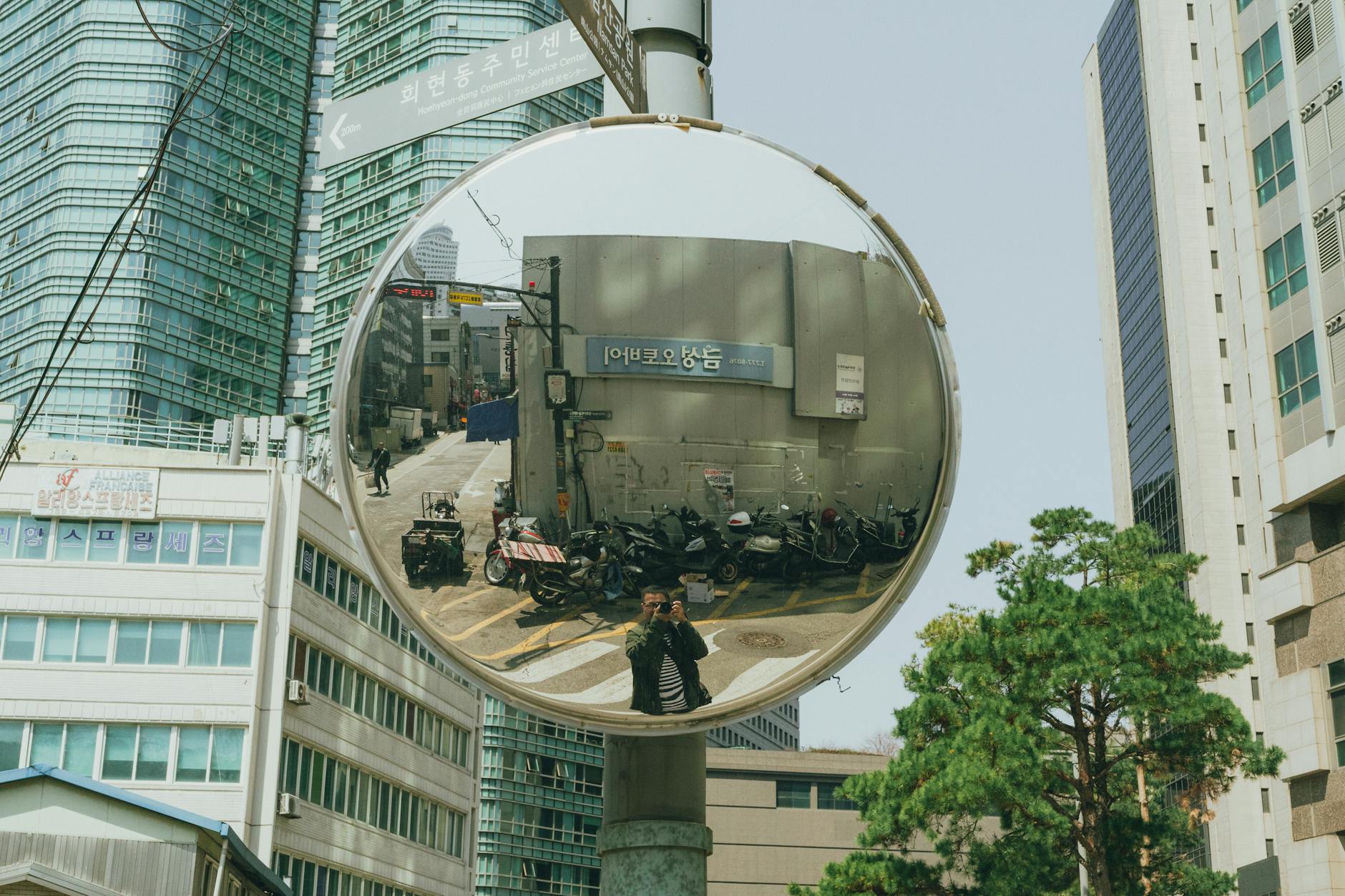 A captivating street scene reflection in a convex mirror in downtown Seoul, South Korea.