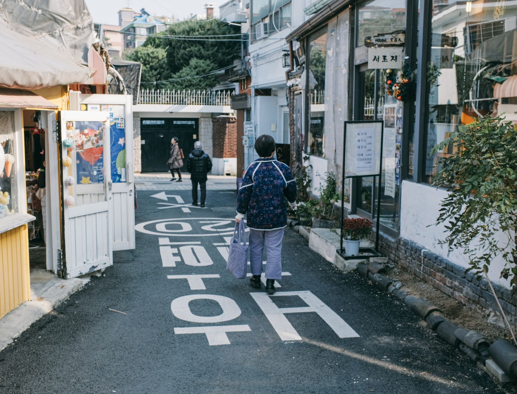 A quaint pedestrian street in Seoul, South Korea, showcasing local shops and daily life.