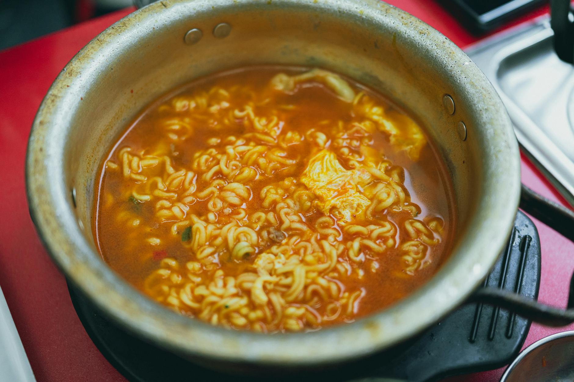 A steaming pot of Korean ramen with rich broth, capturing authentic flavors of Seoul.