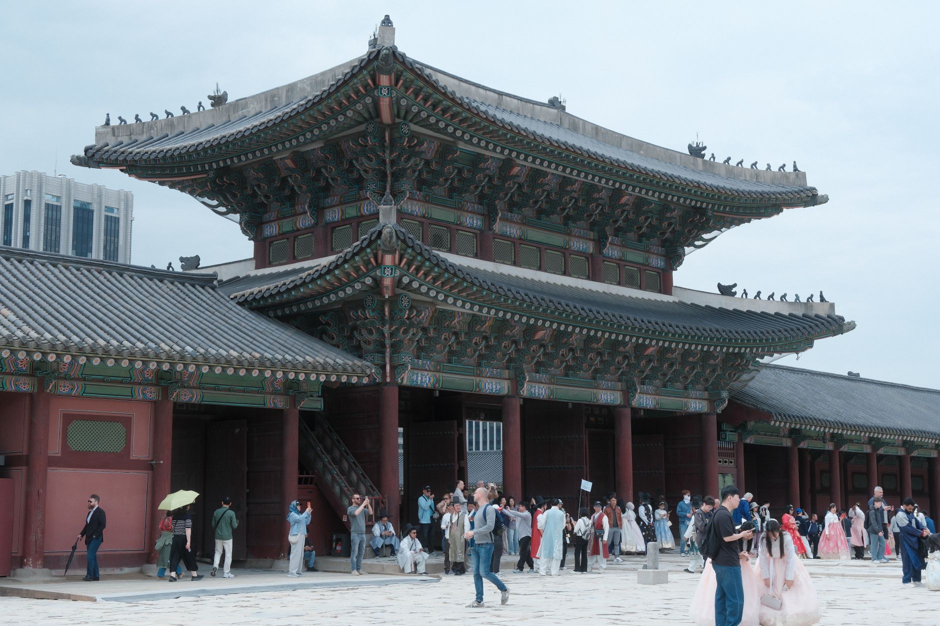 Visitors exploring Gyeongbokgung Palace in Seoul, South Korea, showcasing traditional architecture.