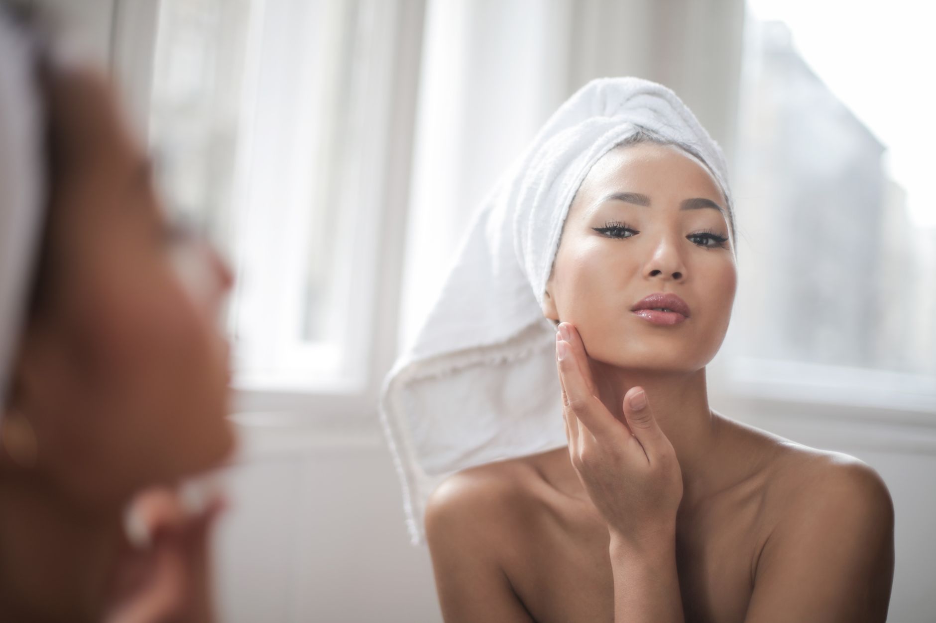 Korean skincare products and a towel, part of a daily glass-skin routine.