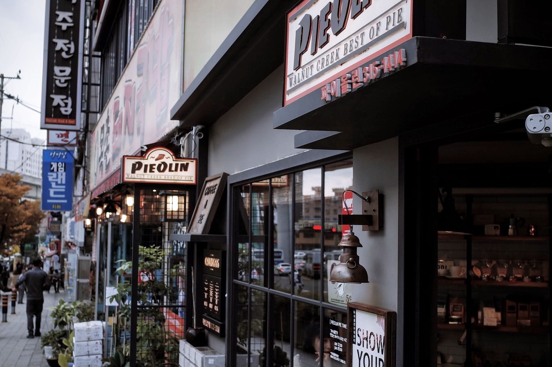 Explore the lively streets of Gamjeon-dong, Busan featuring shops and cafes.